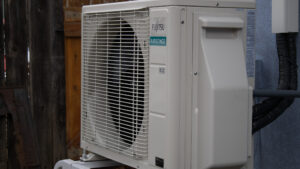 Wall-mounted ductless mini-split indoor unit providing zoned cooling in a modern living room.